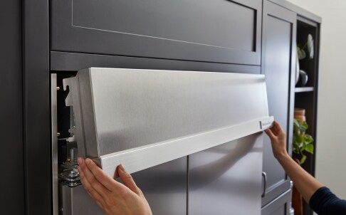 Removing top grille from refrigerator